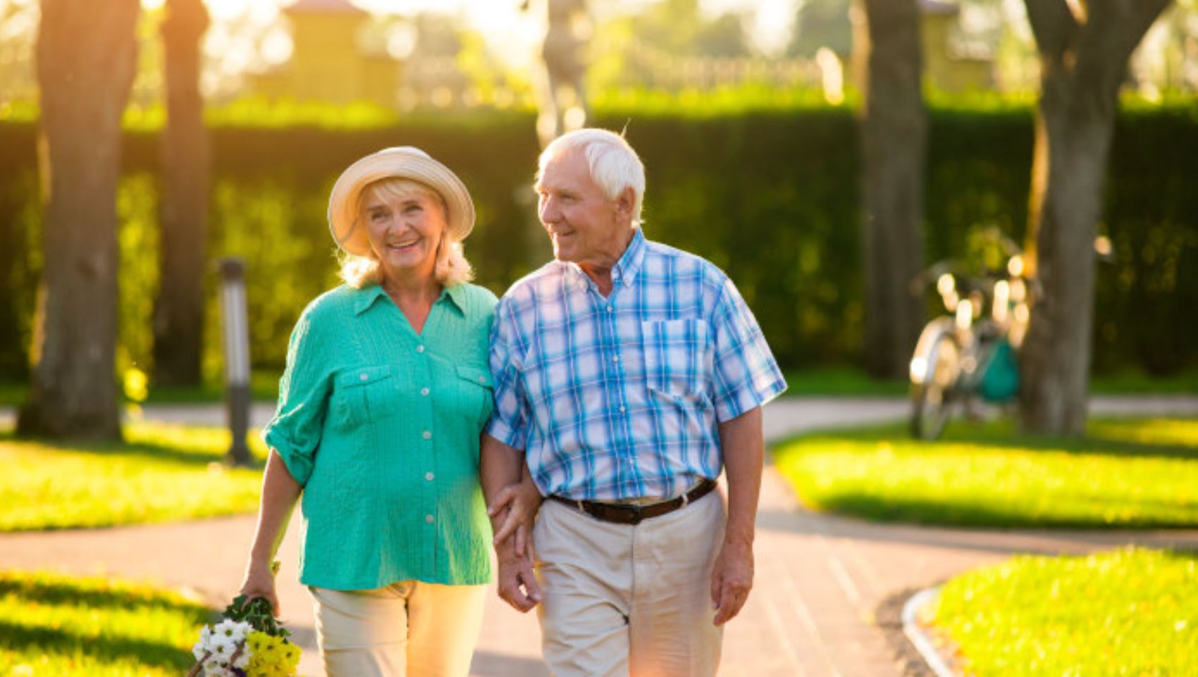 a senior couple out for a walk in a park